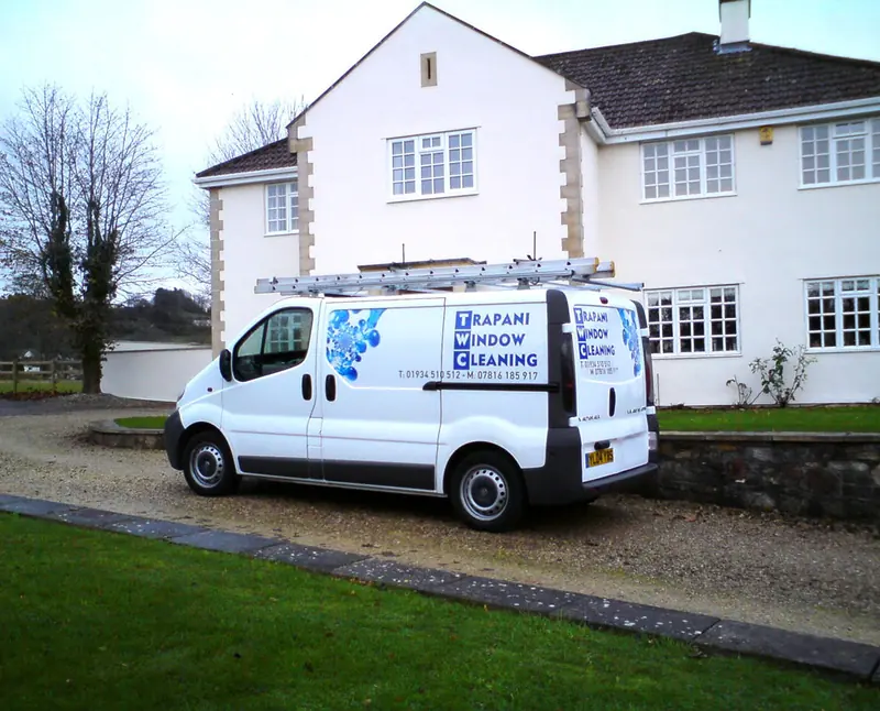 Trapani Window Cleaning van parked outside a large white house